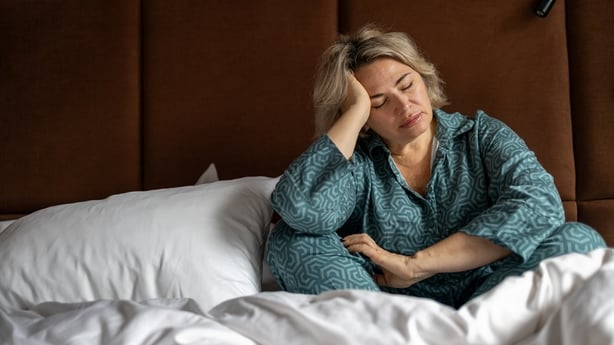 Mature woman crying from a headache 