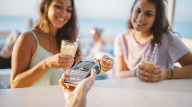 Friends buying drinks at a bar