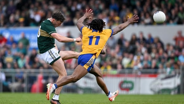 David Clifford of Kerry shoots at goal despite the attention of Ikem Ugwueru of Clare during the Munster GAA Football Senior Championship semi-final match between Kerry and Clare at Zimmer Biomet Páirc Chíosóg in Ennis, Clare.