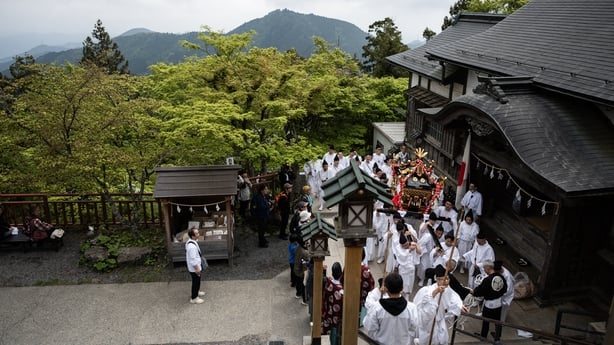 Devotees pause before making the final ascent to the mountaintop