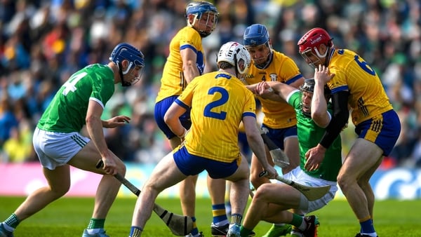 Clare and Limerick players battle for possession during the 2025 Munster round-robin clash at TUS Gaelic Grounds