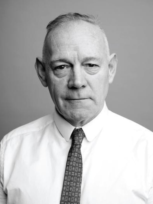 Black and white image of candidate Mannix Flynn in a suit