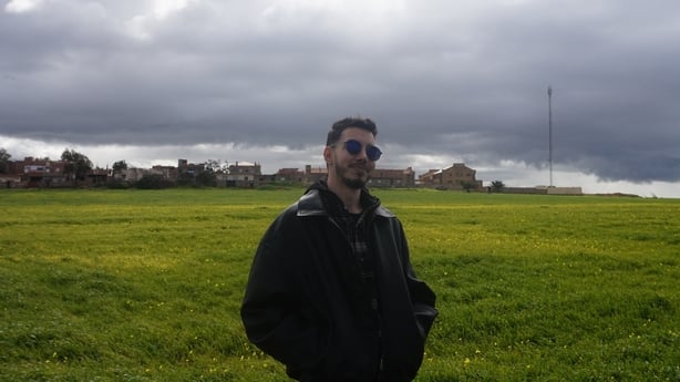 A man with sunglasses in a field