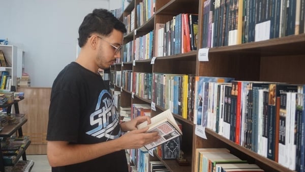 A man holding a book in a library