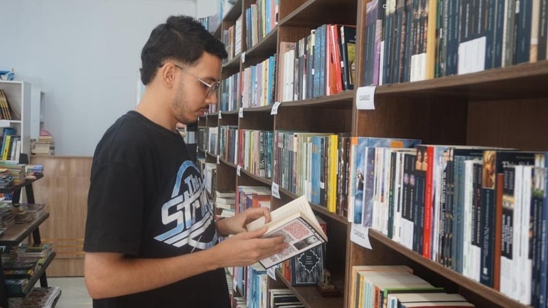 A man holding a book in a library