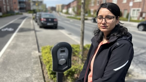 Bhawna Rana standing beside an EV charger