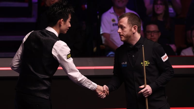 Mark Allen of Northern Ireland shakes hands with Wu Yize of China prior to the semi final match on day thirteen of the Halo World Snooker Championship at The Crucible Theatre on April 30, 2026 in Sheffield, England.