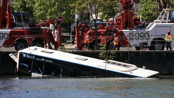 A bus is removed from the Seine river