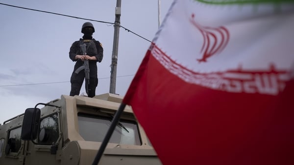 An armed Iranian police officer stands guard on an armored vehicle in Tehran, Iran.