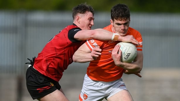 27 April 2024; Jarlath Óg Burns of Armagh is tackled by Ryan McEvoy of Down during the Ulster GAA Football Senior Championship semi-final match between Down and Armagh at St Tiernach's Park in Clones, Monaghan. Photo by Stephen McCarthy/Sportsfile