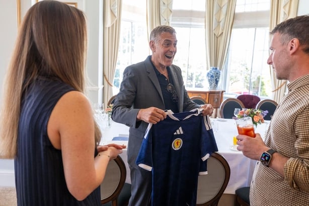 Handout photo dated 30/04/26 issued by Social Bite/Itison of Claire Phale (left) and George Clooney at the Gleaneagles Hotel, Auchterarder. Claire presented George with personalised Scotland strips for George, Amal and their 8-year-old twins. Picture date: Thursday April 30, 2026. PA Photo. Photo cr