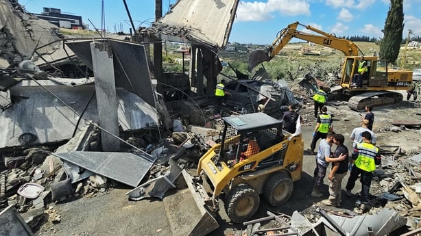 First responders search for survivors amongst the rubble at the site of an Israeli airstrike that targeted the southern Lebanese village of Ain Baal on May 1, 2026. Israeli airstrikes on southern Lebanon killed at least 17 people on April 30, 2026, the Health Ministry announced, despite the ceasefir