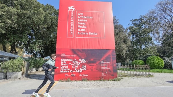 VENICE, ITALY - MARCH 19: A person runs past a display at the Venice Biennale during the opening of the Central Pavilion on March 19, 2026, in Venice, Italy. The Central Pavilion has been renovated in preparation for the 61st International Art Exhibition.
