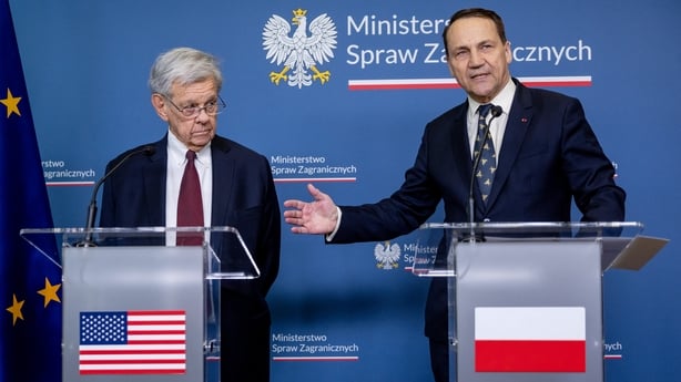 Polish Foreign Minister Radoslaw Sikorski (R) gestures as the US President's Special Envoy for Belarus John Cole listens as they address a press conference at the ministry building in Warsaw on April 28, 2026, after an exchange of prisoners. Poland on April 28 released a jailed Russian archaeologist