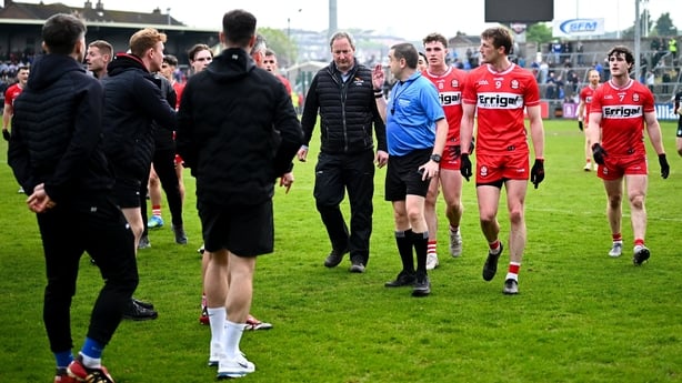 2 May 2026; Derry players speak with referee Noel Mooney as they leave the pitch ahead of extra-time during the Ulster GAA Football Senior Championship semi-final match between Derry and Monaghan at BOX-IT Athletic Grounds in Armagh. Photo by Shauna Clinton/Sportsfile