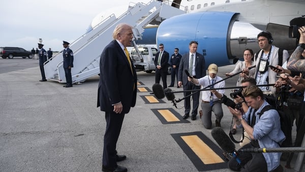 U.S. President Donald Trump speaks to journalists before boarding Air Force One at Palm Beach International Airport