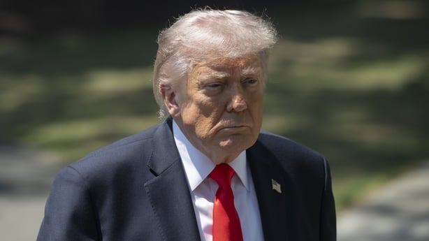 United States President Donald Trump speaks to the press before departing the White House.