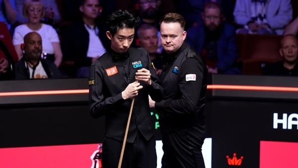 Wu Yize (left) during his match against Shaun Murphy