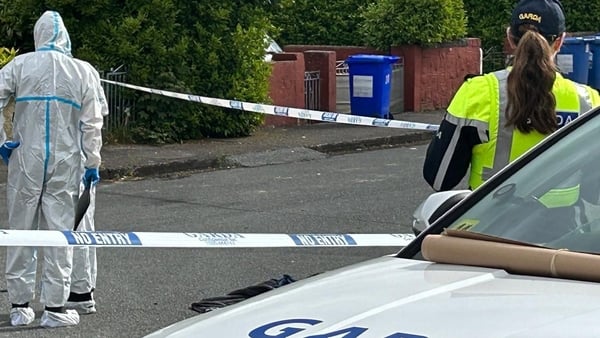 garda forensic officers, crime scene tape and a female garda pictured at a crime scene