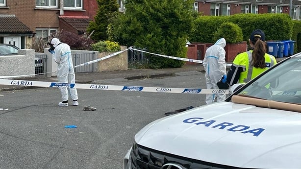 garda forensic officers, crime scene tape and a female garda pictured at a crime scene