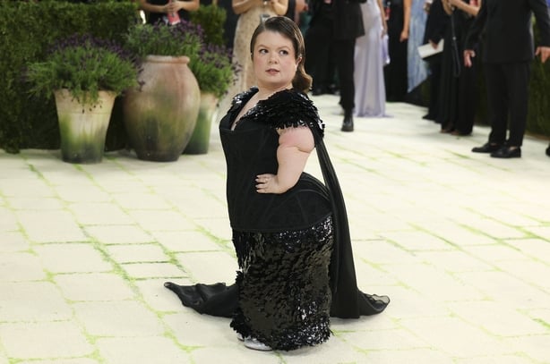 Irish educator activist Sinead Burke wearing a glittering black gown poses for photographers at the 2026 Met Gala
