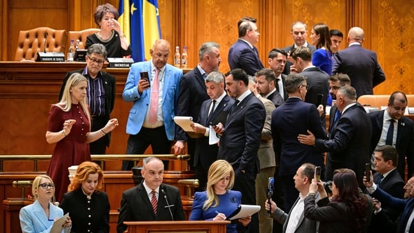 Members of Parliament observe and record the voting procedure in Parliament in Bucharest on May 5, 2026 following a motion of no confidence against pro-EU Prime Minister Ilie Bolojan