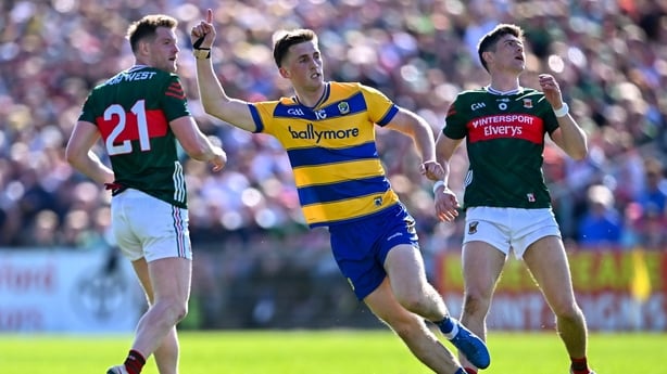 26 April 2026; Dylan Ruane of Roscommon celebrates scoring a point, as Mayo players Matthew Ruane, left, and Conor Loftus look on, during the Connacht GAA Football Senior Championship semi-final match between Mayo and Roscommon at Hastings Insurance MacHale Park in Castlebar, Mayo. Photo by Piaras Ó