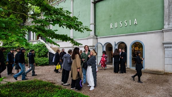 Visitors explore the Russian Pavilion at Giardini at the 61st International Art Exhibition