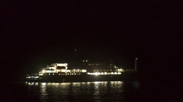 A general view of the cruise ship MV Hondius at night with its lights on