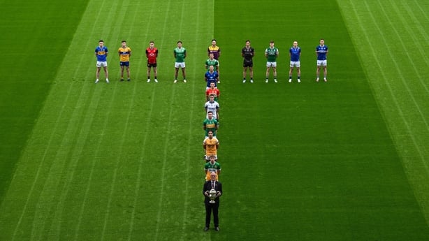 5 May 2026; Uachtarán Chumann Lúthchleas Gael Jarlath Burns, centre, holding the Tailteann Cup, alongside front row from front to back, Lee Pearson of Offaly, Eoghan McCabe of Antrim, Ryan O'Rourke of Leitrim, Conor Murray of Waterford, Mikey Bambrick of Carlow, Dean Healy of Wicklow, and Cillian Fa