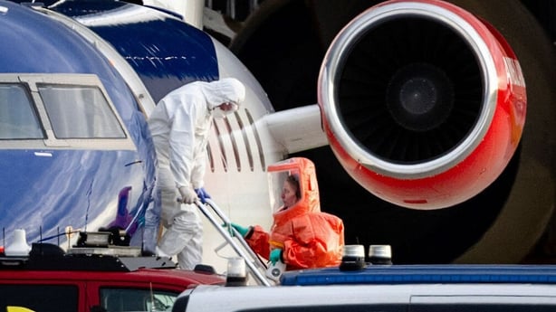 Person in a white hazmat suit disembarks a Bombardier Challenger 605 medical aircraft allegedly carrying some of the passengers believed to be infected with hantavirus from the cruise ship MV Hondius