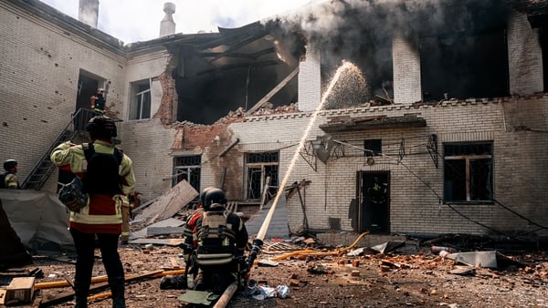 Firefighters work at the site of a Russian drone strike on a kindergarten in Sumy, Ukraine