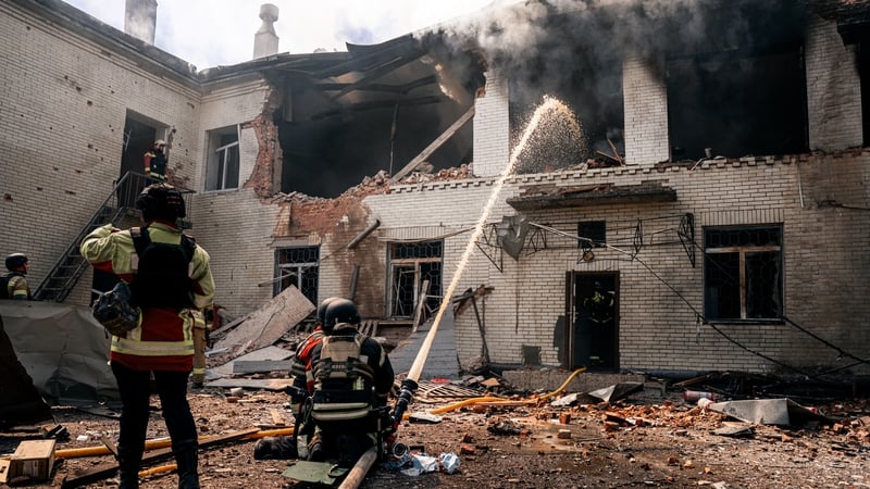 Firefighters work at the site of a Russian drone strike on a kindergarten in Sumy, Ukraine