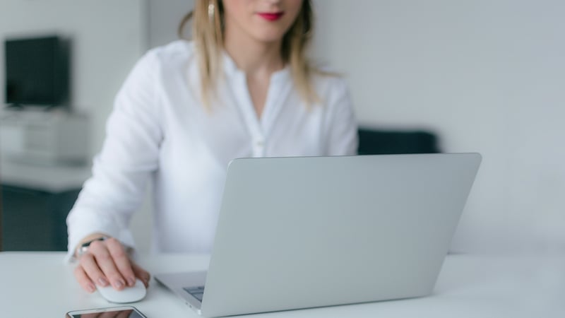 Woman on laptop using mouse (Photo by Marek Levák on Unsplash)