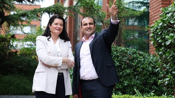 Image of a woman and a man in the garden of an office block