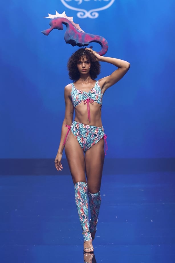 A model walks the runway at the Agüita Swimwear fashion show