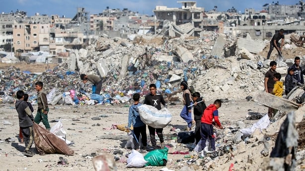 Children sift through rubbish at the Nuseirat camp for Palestinian refugees in the central Gaza Strip
