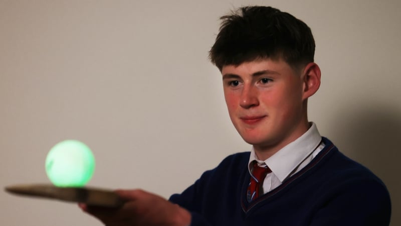 Cathal Sweeney balances a green glo ball on a hurley