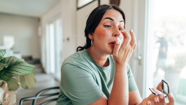 woman using make up products at home