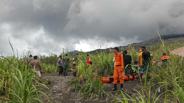 rescue workers with stretchers in an open field