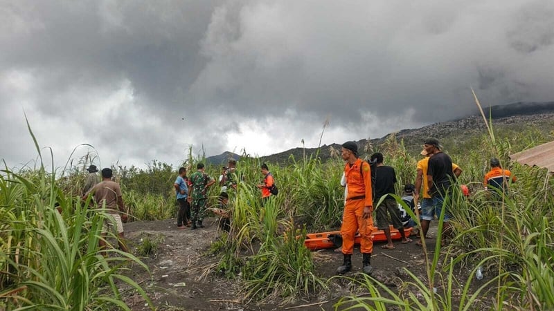 rescue workers with stretchers in an open field