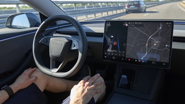 The editorial image shows the interior of the new Tesla Model 3 with Full Self-Driving activated. The photograph highlights the advanced autonomous driving system and the innovative design of Tesla's electric vehicles, representing the future of mobility