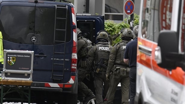 Police and rescue services are seen near a bank, where bank robbers have taken multiple hostages in Sinzig, western Germany
