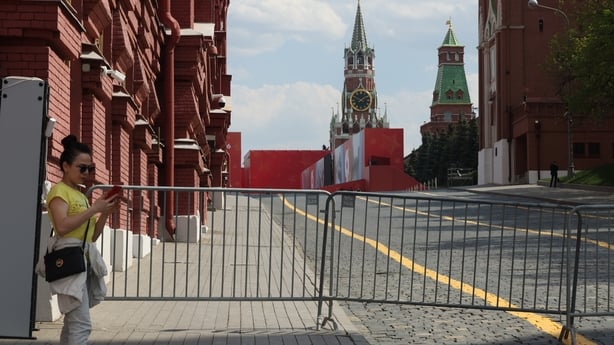 MOSCOW, RUSSIA - MAY 7: A woman looks at her mobile phone against the backdrop of the Kremlin, on May 7, 2026 in Moscow, Russia. Russian cellular operators announced to shut down mobile internet for a day at the request of the authorities in connection with a parade in Moscow planned on May 9 and de