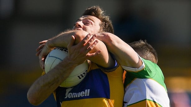 Cillian Brennan of Clare is tackled by Dylan Hyland of Offaly during the Táilteann Cup round 1 match between Clare and Offaly at Zimmer Biomet Páirc Chíosóg in Ennis, Clare. 