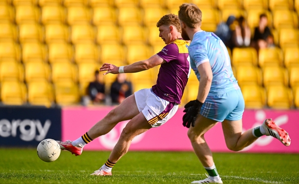 Michael Kinsella of Wexford scores his side's second goal as Limerick goalkeeper Jeffrey Alfred closes in during the Tailteann Cup round 1 match between Wexford and Limerick at Chadwicks Wexford Park in Wexford. 