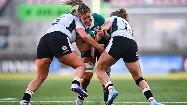 9 May 2026; Erin King of Ireland is tackled by Wales players Kelsey Jones, left, and Carys Cox during the Women's 6 Nations Rugby Championship match between Ireland and Wales at Affidea Stadium in Belfast. Photo by Shauna Clinton/Sportsfile