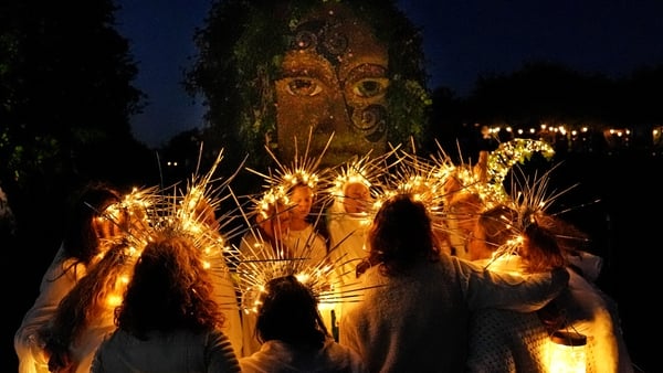 Performers chant in front of a statue of the Celtic godess Eriu during the Bealtaine Fire Festival