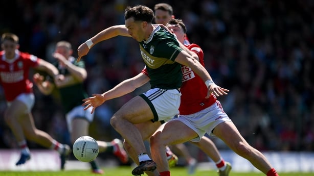 David Clifford of Kerry has a shot on goal as he is tackled by Daniel O'Mahony of Cork during the Munster GAA Football Senior Championship final match between Kerry and Cork at Fitzgerald Stadium in Killarney, Kerry.