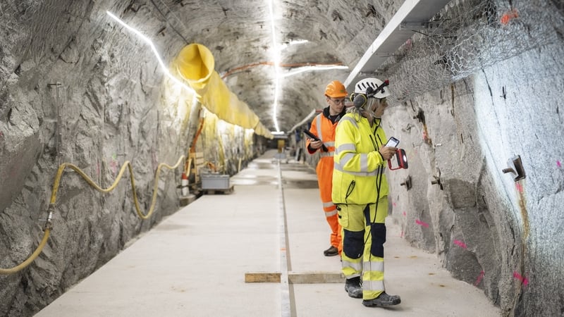 ETH Zurich Master students Alba Zappone (R) and Alessandro Profeta (rear) examine the cracks in the BedrettoLab tunnel beneath the Swiss Alps